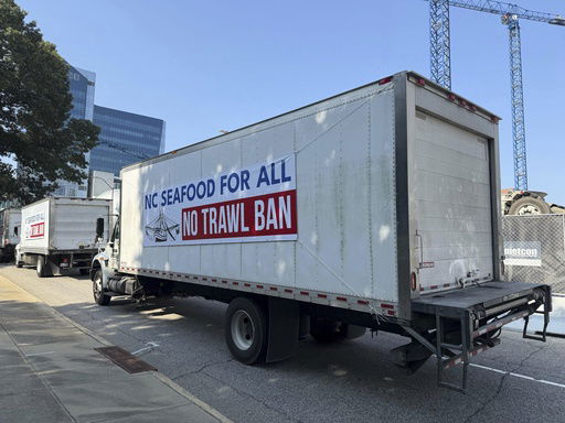A caravan of semi-trucks circles around the North Carolina Legislative Building in Raleigh