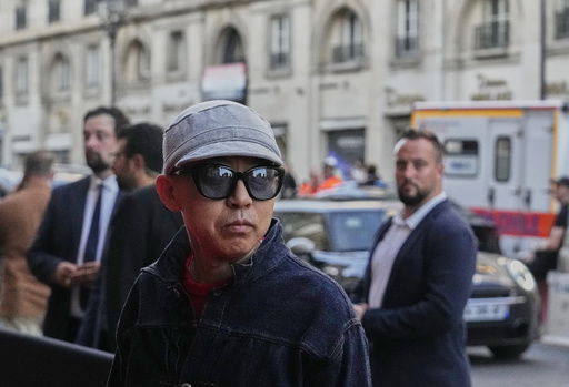 Designer Nigo poses for photographers following the men's Kenzo Spring-Summer 2026 collection