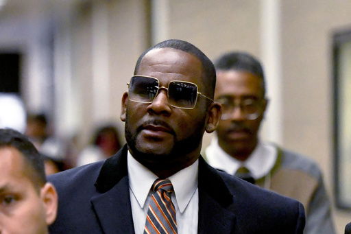 FILE - R. Kelly leaves the Daley Center after a hearing in his child support case May 8
