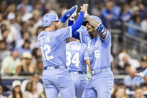 Kansas City Royals' Nick Loftin (12) celebrates after a home run by Jonathan India (6) in the fifth inning of a baseball game against the San Diego Padres