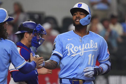 Kansas City Royals' Maikel Garcia celebrates his home run that scored teammates Jonathan India and Bobby Witt Jr. during the fourth inning of a baseball game against the Texas Rangers