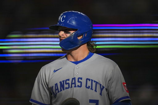 Kansas City Royals' Bobby Witt Jr. returns to the dugout after scoring on a single by Maikel Garcia during the first inning of a baseball game against the Texas Rangers Tuesday