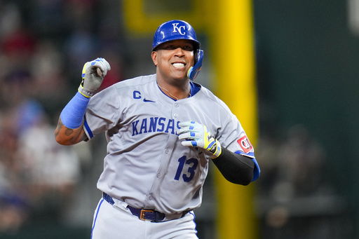 Kansas City Royals' Salvador Perez reacts after hitting a solo home run off Texas Rangers starting pitcher Jack Leiter during the sixth inning of a baseball game Tuesday