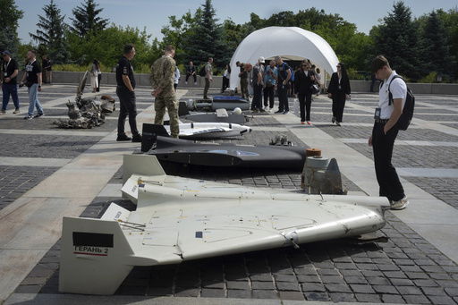 Visitors check damaged Russian drones during the International Conference on Expanding Sanctions Against Russia in Kyiv