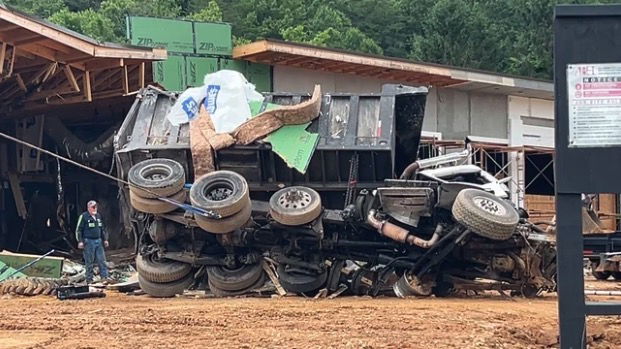 <i>WLOS via CNN Newsource</i><br/>The scene of a fatal crash is pictured near Exit 73 along Interstate 40 in Old Fort. Police say the dump truck lost its brakes and exited the interstate before going airborne and crashing into the building.