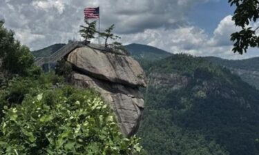 An American flag sits at the top of Chimney Rock State Park.