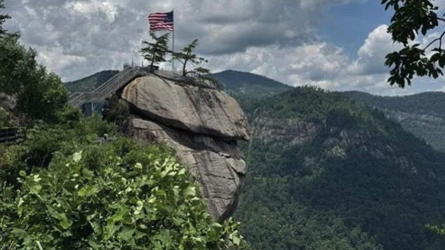 <i>WLOS via CNN Newsource</i><br/>An American flag sits at the top of Chimney Rock State Park.
