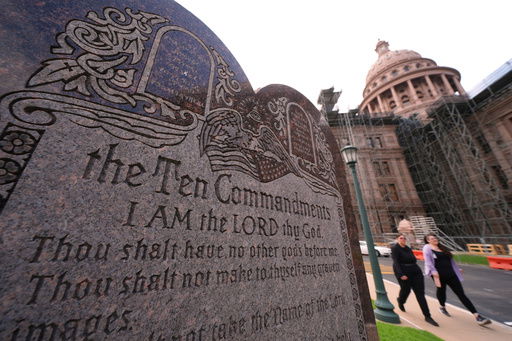 A granite Ten Commandments monument stands on the ground of the Texas Capitol