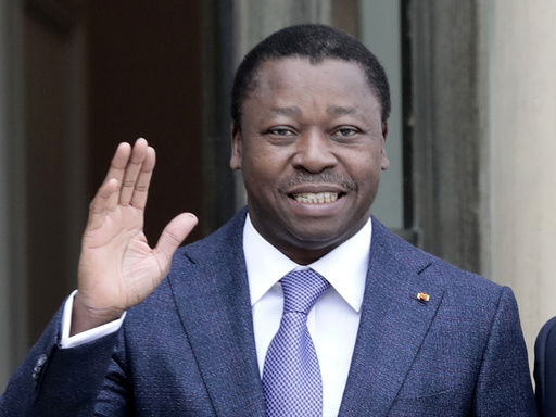 FILE - Togo's President Faure Gnassingbe waves before a working lunch at the Elysee Palace in Paris on April 9