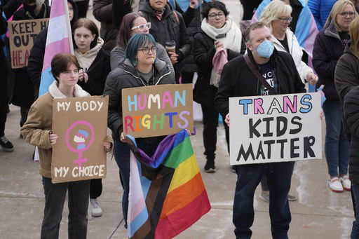 FILE - People gather in support of transgender youth during a rally at the Utah State Capitol Tuesday