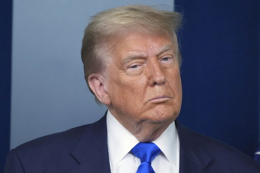 President Donald Trump listens during a briefing with the media