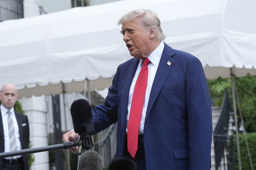 President Donald Trump speaks with reporters as White House Deputy Chief of Staff Stephen Miller listens before departing the White House on his way to attend the G7 Summit in Canada