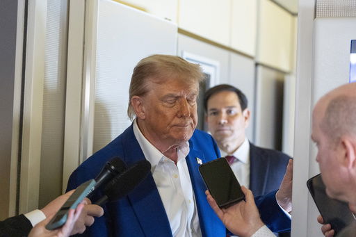 President Donald Trump turns to depart after speaking with reporters on Air Force One while in flight from Joint Base Andrews