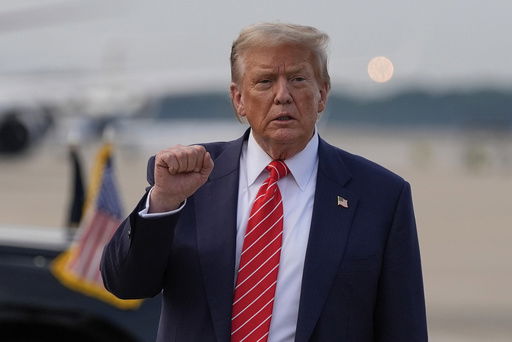 President Donald Trump gestures after arriving on Air Force One