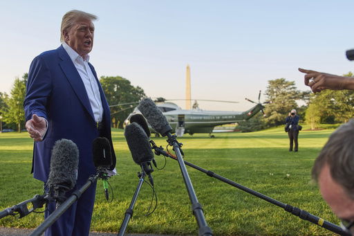 President Donald Trump speaks with reporters before boarding Marine One on the South Lawn of the White House