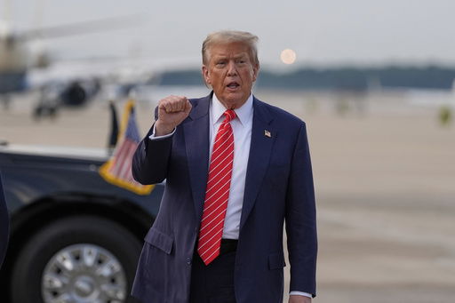 President Donald Trump gestures after arriving on Air Force One