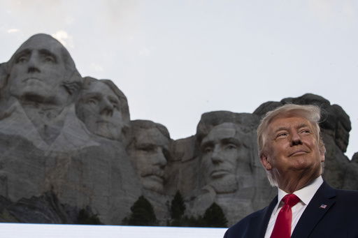 FILE - Then-President Donald Trump stands at Mount Rushmore National Memorial on July 3
