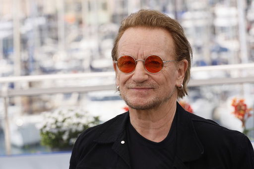 FILE - Bono poses for photographers at the 78th international film festival