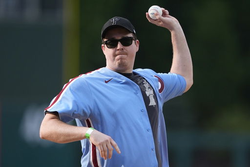 FILE - Comedian Shane Gillis throws out a pitch before a baseball game between the Philadelphia Phillies and the Texas Rangers