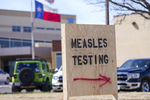 FILE - A sign is seen outside of Seminole Hospital District offering measles testing