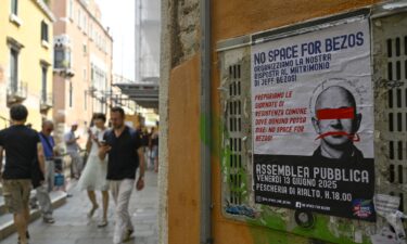 Protesters display a banner reading "No Space for Bezos!" on the Rialto Bridge.