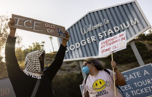 A small group of demonstrators protests outside the entrance of Dodger Stadium on Thursday