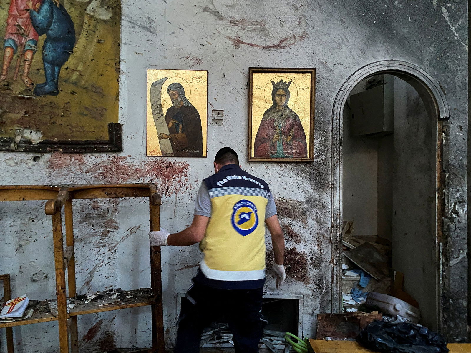 <i>Firas Makdesi/Reuters via CNN Newsource</i><br/>A member of the Syrian security force inspects the damage after a reported attack at the Mar Elias Church in the Dweila neighbourhood of Damascus