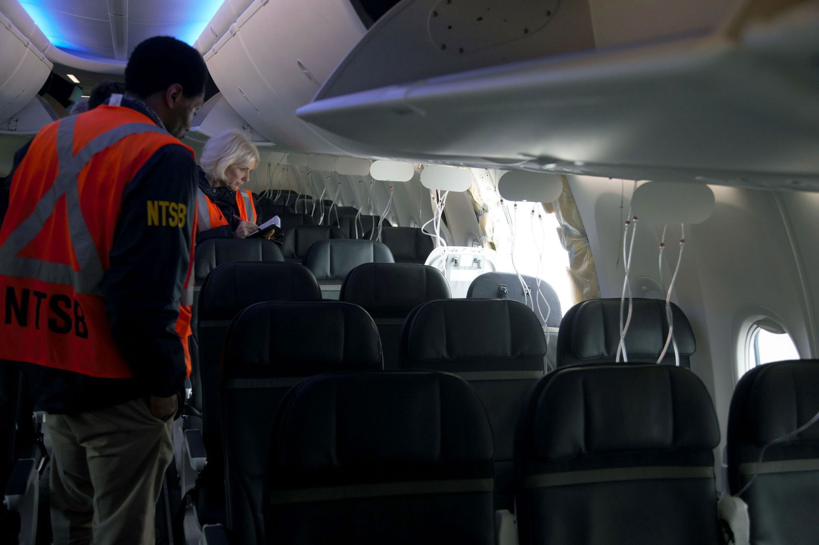 <i>NTSB/Getty Images via CNN Newsource</i><br/>Members of the NTSB examine the hole in the fuselage plug area of Alaska Airlines Boeing 737 Max flight in which a door plug blew out in January 2024.