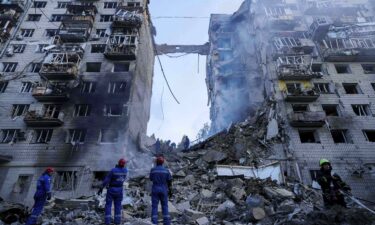 Rescue workers clear the rubble of a multi-storey residential house destroyed by a Russian strike in Kyiv