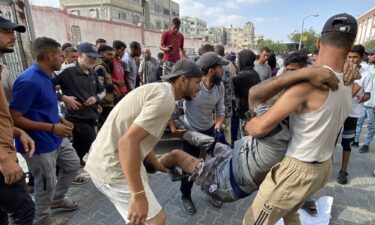 Palestinians transport an injured man to Nasser Medical Complex in southern Gaza after the Palestinian Ministry of Health said that over 50 people had been killed while seeking aid in Khan Younis on Tuesday.