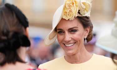 The Princess of Wales greets guests during a Royal Garden Party at Buckingham Palace on May 20 in London