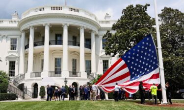 President Donald Trump speaks as a flagpole is installed on the South Lawn of the White House on June 18
