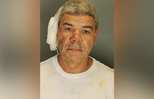 Law enforcement officers detain Soliman following the attack that injured multiple people on June 1.