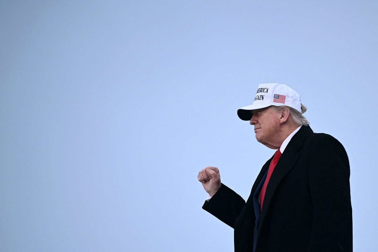 <i>Brendan Smialowski/AFP/Getty Images via CNN Newsource</i><br/>President Donald Trump raises a fist as he steps off of Air Force One upon arrival at Calgary International Airport