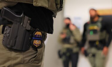 An ICE officer's badge is seen as federal agents patrol the halls of immigration court at the Jacob K. Javitz Federal Building in New York City.