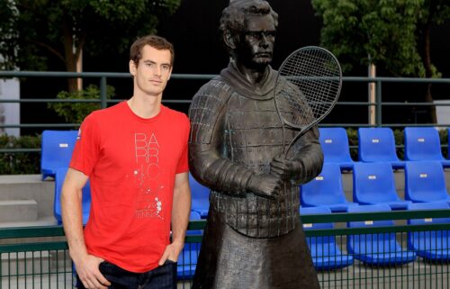 Andy Murray poses next to his terracotta warrior.