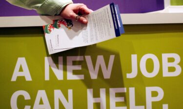 A man holds pamphlets as he waits at a job fair sponsored by employment website Monster.com in 2009. The website filed for bankruptcy 16 years later.