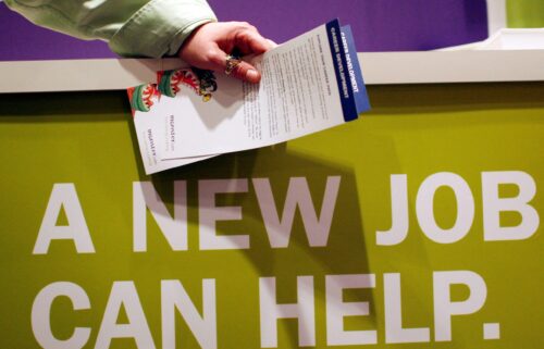 A man holds pamphlets as he waits at a job fair sponsored by employment website Monster.com in 2009. The website filed for bankruptcy 16 years later.