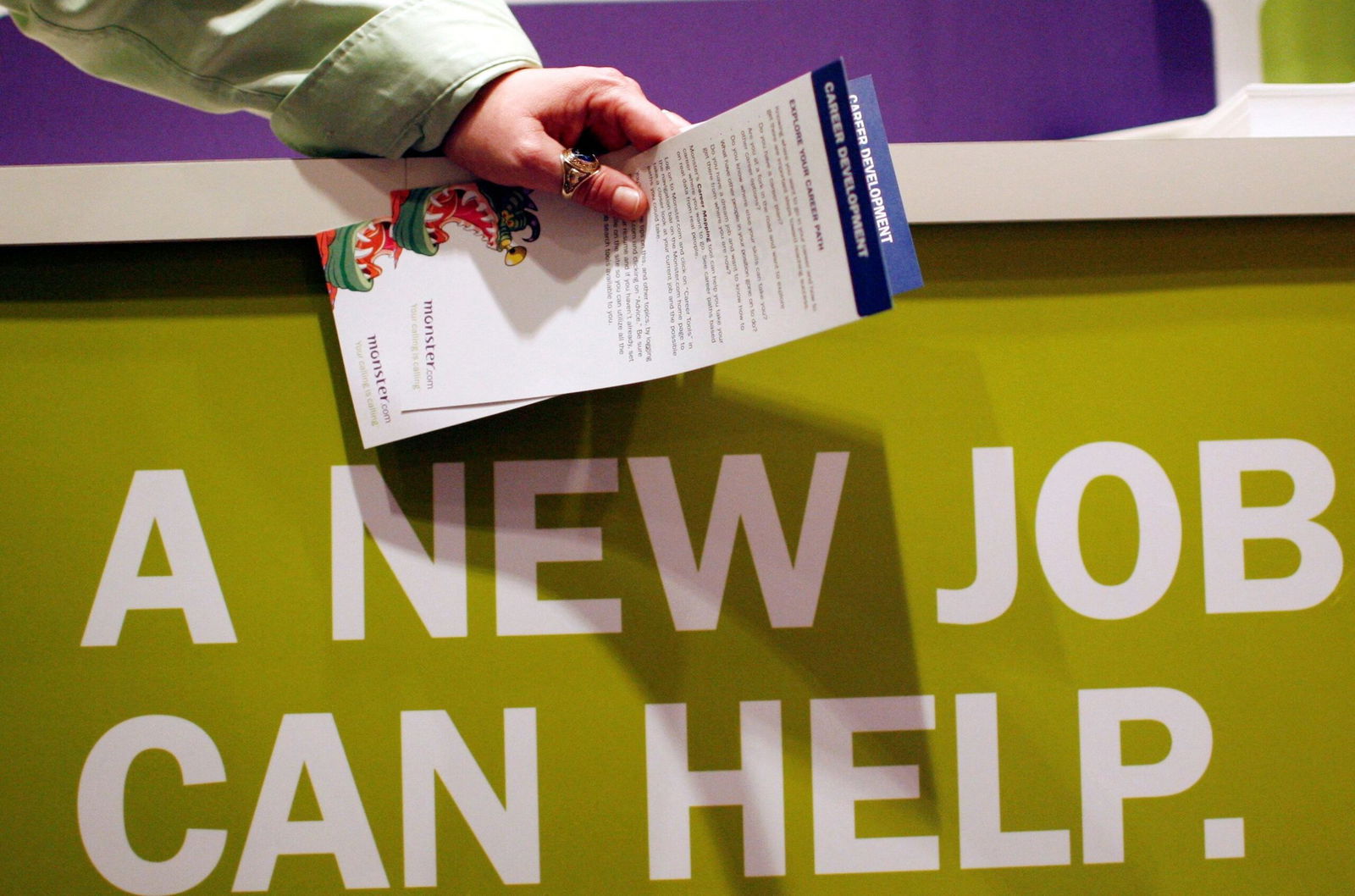 <i>Mike Segar/Reuters/FILE via CNN Newsource</i><br/>A man holds pamphlets as he waits at a job fair sponsored by employment website Monster.com in 2009. The website filed for bankruptcy 16 years later.