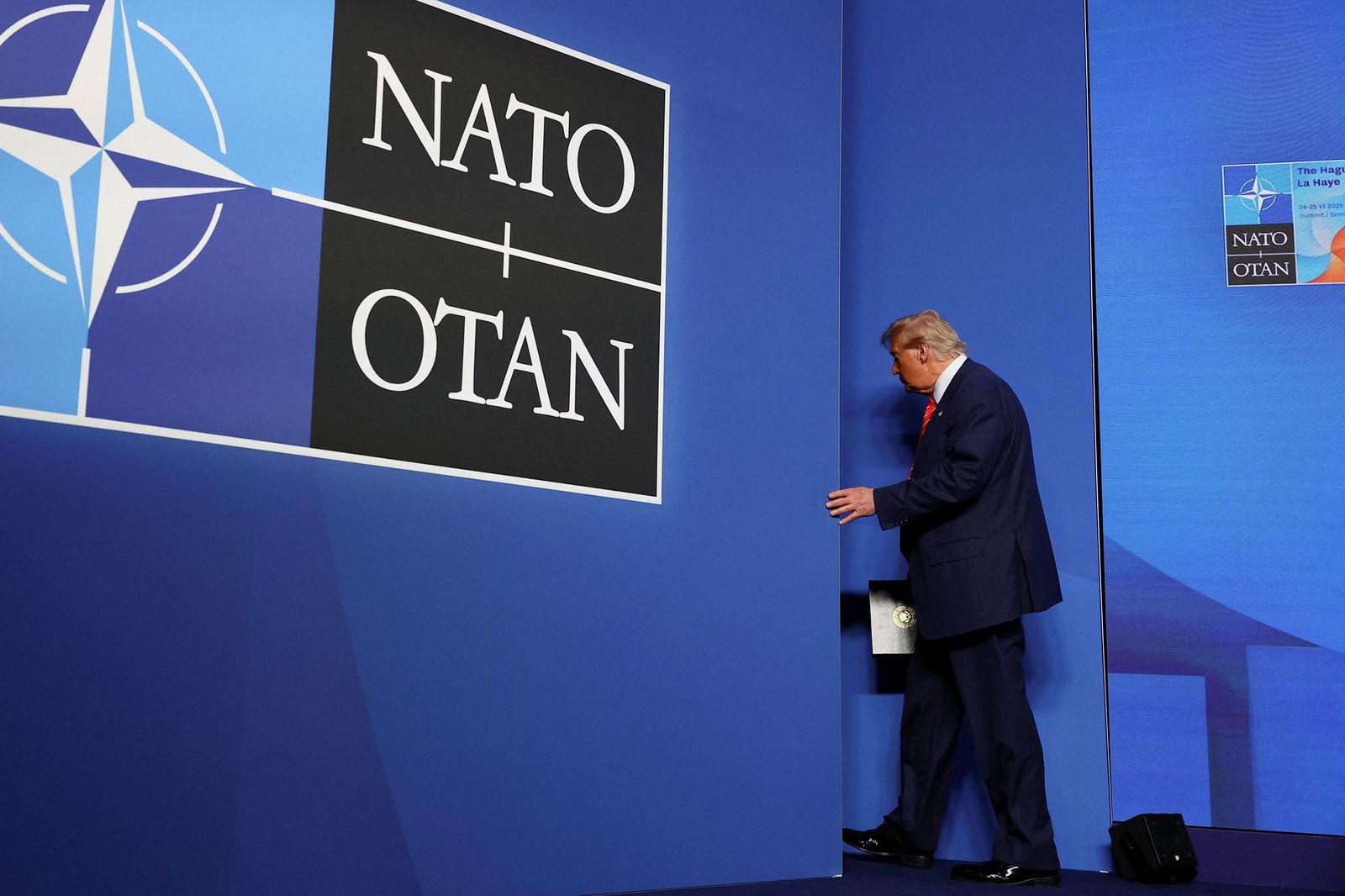 <i>Piroschka Van De Wouw/Reuters via CNN Newsource</i><br/>President Donald Trump leaves following a press conference at the NATO summit in The Hague