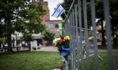 Flowers and a flag at the site of the attack outside the Boulder County Courthouse in Boulder