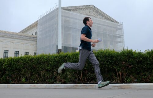 CNN's Max Rego runs out of the US Supreme Court building carrying an ruling during the last day of the court's term on June 27
