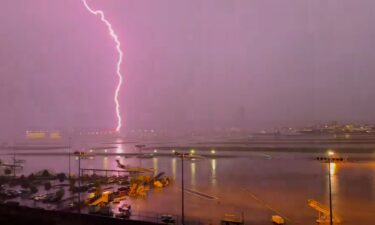 A lightning strike is seen from Atlanta’s Hartsfield-Jackson International Airport on Friday.