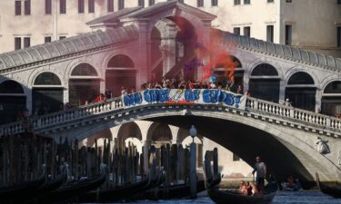 Demonstrators on the Rialto Bridge stand by a banner that reads 'No space for Bezos' in Venice on Saturday.