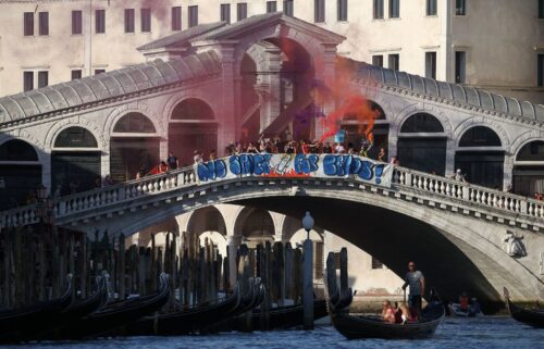 Demonstrators on the Rialto Bridge stand by a banner that reads 'No space for Bezos' in Venice on Saturday.