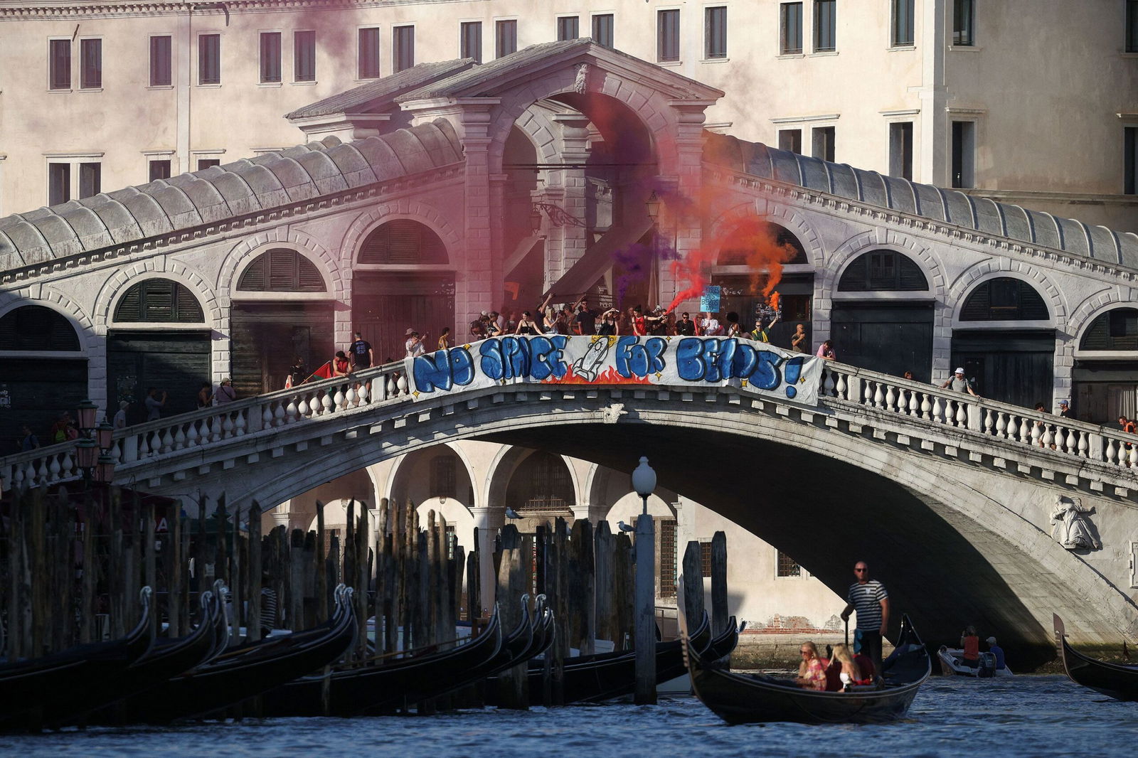 <i>Guglielmo Mangiapane/Reuters via CNN Newsource</i><br/>Demonstrators on the Rialto Bridge stand by a banner that reads 'No space for Bezos' in Venice on Saturday.