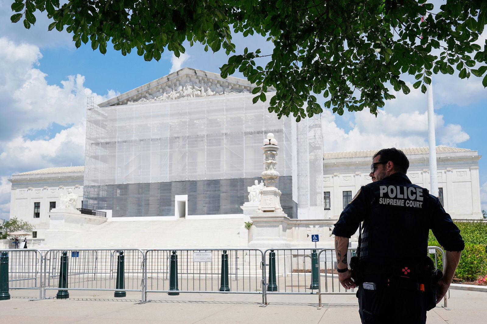 <i>Mariam Zuhaib/AP via CNN Newsource</i><br/>A US Supreme Court police officer stands watch outside of the Supreme Court on June 26 in Washington
