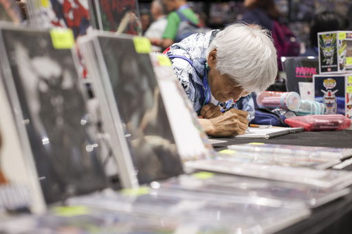 An artist draws during preview night for Comic-Con International on Wednesday