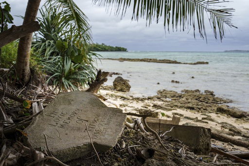 A gravestone lies just feet from the shoreline on Pele Island