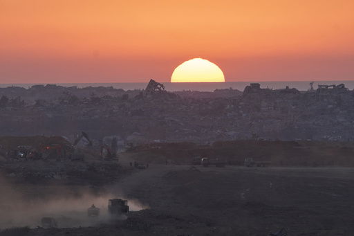 Israeli army vehicles moves in the Gaza Strip as seen from southern Israel on Sunday